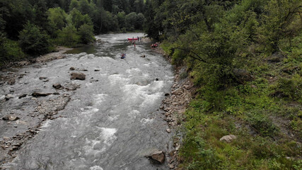 Rafting on a mountain river. White foam of seething water.