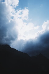 view of the mountains on a sunny cloudy summer day.