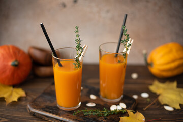 freshly squeezed pumpkin juice with thyme in tall glasses