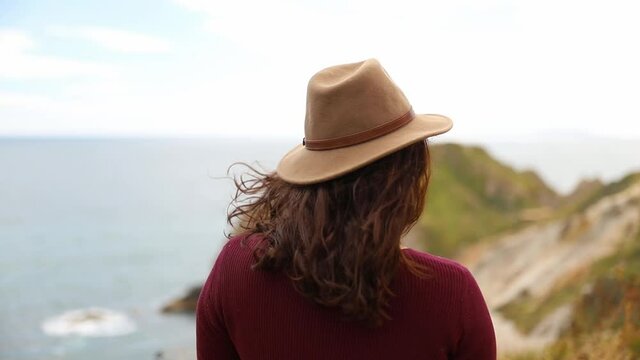 Woman Enjoying the View of the Jurassic Coast During a Windy Day