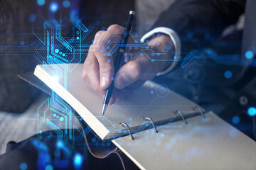 Businessman in suit taking notes. Double exposure with binary tech theme hologram. Man writing down...