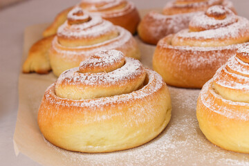 Soft, fluffy buns sprinkled with powdered sugar