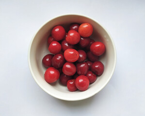 A plate of fresh red cherries. Healthy food. Season fruits.