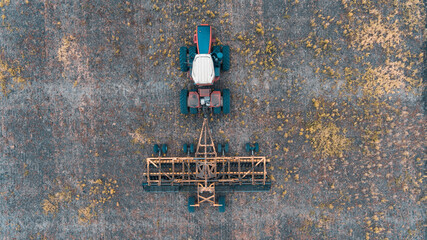 tractor in the field with a disc harrow