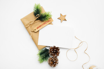 Top view of Christmas composition with gift box, ribbon, fir branches, cones, anise on white background with copy space.