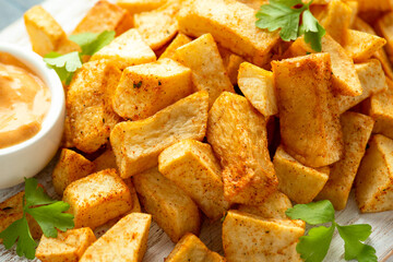 Patatas bravas traditional Spanish potatoes snack tapas on white wooden board