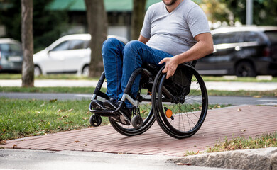 Handicapped man in wheelchair crossing street road
