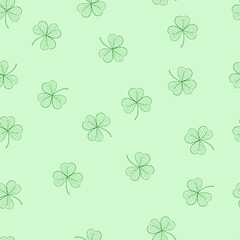 Fototapeta premium Seamless pattern with green leaves of clover on a green background. Suitable for congratulations to the St. Patrick's day, cards, patterns, logos, textiles, packaging.