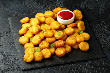Mini hash browns, tater tots crispy golden potato bites served with jalapeno peppers dipped in ketchup
