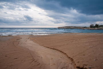 Sunset on the background of the sandy seashore