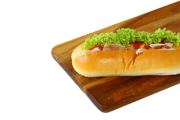 Hot dog with lettuce bacon and ketchup on wooden cutting board and isolated on white background. Sausage & bun