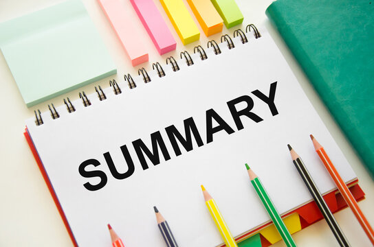 word summary written on notepad with markers and pencils. a summary of the material.
