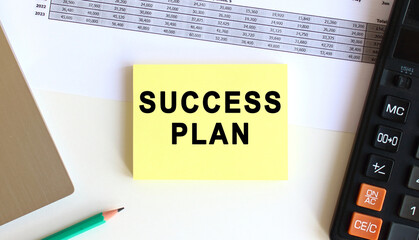 The inscription on the yellow sticky notes near to the laptop and calculator. Business concept.