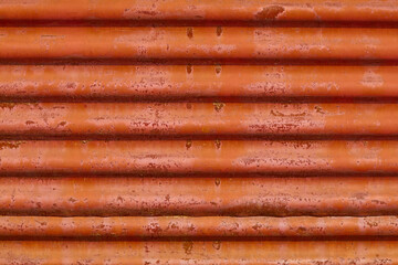 close up of a stack of pipes red background