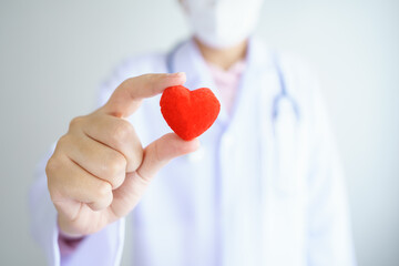 Heart check Doctor holding Red heart on hands at hospital office.Healthcare And Medical concept.