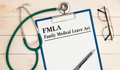 Paper with Family Medical Leave Act FMLA on a table
