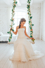 Fototapeta premium Wedding day and beautiful bride in studio. Beautiful young bride with wedding makeup and hairstyle. Portrait of young gorgeous bride. Wedding.