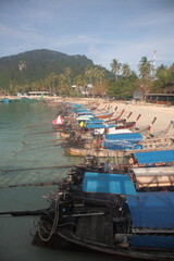 View of Phi Phi islands  main arrival port Tonsai bay with pier view and ferry boats in Phuket, Krabi province, Thailand 