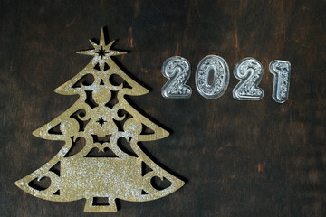 christmas tree made of wood and 2021 on wooden rustic background