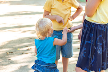 Children hold a compass in their hand and do not know where to go, hiking and tourism concept.