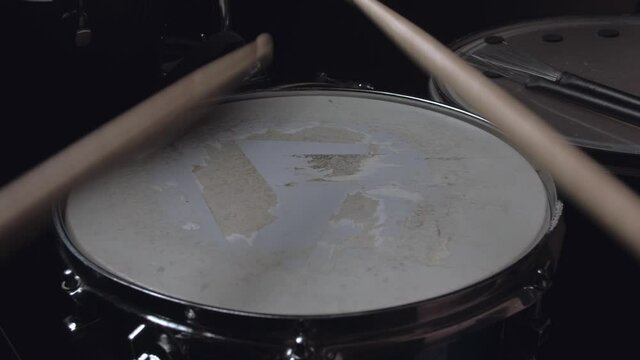 pov - the drummer take drum sticks and plays on a snare drum, home lesson paradiddle training