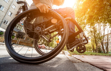Handicapped man in wheelchair crossing street road