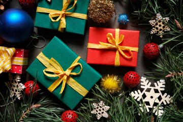 Colorful Christmas gifts and toys on the background of Christmas Tree Branches. Christmastime.