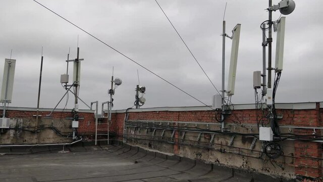 Panel antennas of GSM/DCS/UMTS/LTE bands, optical fibers, power cables and outdoor remote radio units are as part of communication equipment of basic telecommunication station are installed  on roof