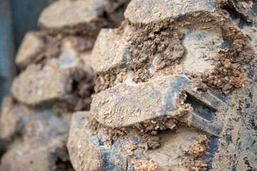 close up of the tire profile of an excavator, a lot of dirt in the profile