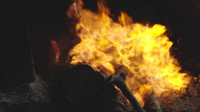 Moonshine Thrown onto Fire Causing Explosion in Slow Motion at Distillery in the Galapagos Islands
