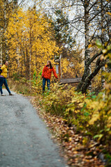 Obraz premium Mother, brother and sister are walking in the beautiful autumn forest. Viivis and strong colors. Shot in Gol, Hallingdal, Norway