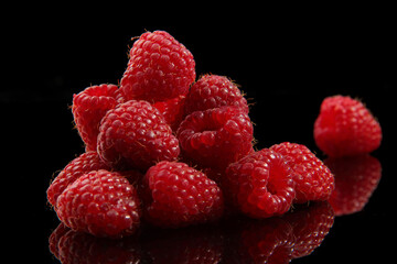 raspberries on black background