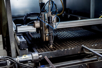 The laser cutting machine cutting the holes on pipes