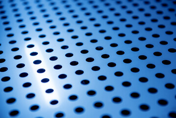 Background sheet of metal with circular holes.