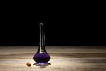 Obraz na płótnie Canvas Old style opened glass bottle with purple liquid. Magic potion or poison. Witchcraft and divination.