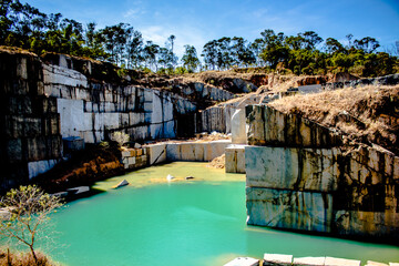 
abandoned quarry landscape with green water