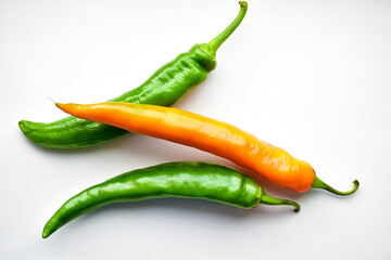 Yellow red and green capsicum on a white background