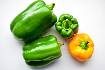 Obraz na płótnie Canvas Yellow green regular pepper on a white background