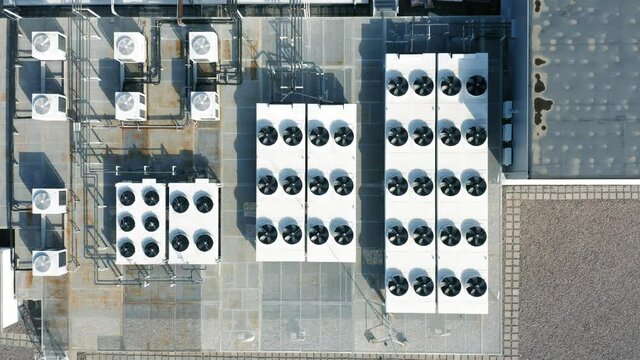 Ventilation and air conditioning systems installed on the rooftop. Aerial top down view
