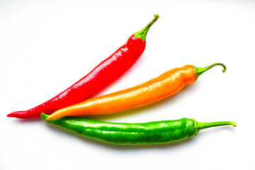 Regular and capsicum yellow and green pepper on a white background