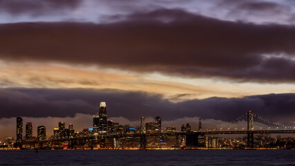 Fototapeta na wymiar Dramatic Sky over San Francisco Downtown via Port View Park in Oakland California