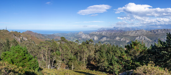 Views of Picos de Europa mountains from Fitu viewpoint (Mirador del Fitu). Ocean and horizon at the...