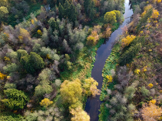 Aerial drone view of autumn forest and small river