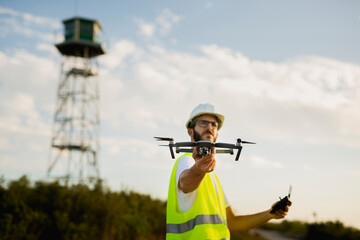 Naklejka na ściany i meble Drone operator Launching a drone on a countryside environment