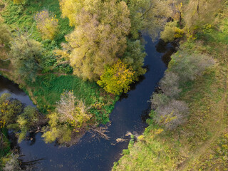 Aerial drone view of autumn forest and small river