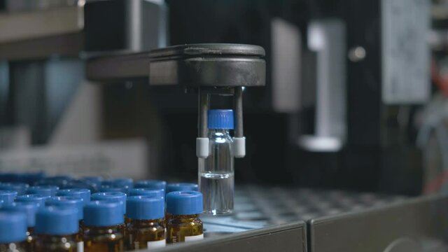 Auto sampler takes a vial and injects a sample into high performance liquid chromatography. 
