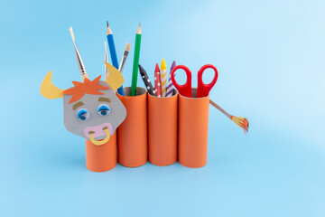 craft bull in the form of a stand for school items made from empty rolls of toilet paper, simple...