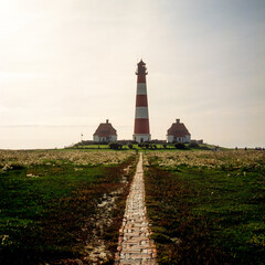 Fototapeta na wymiar On the historic Stockenstieg path through the salt marshes to the Westerhever lighthouse