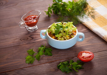 Bean soup, tomatoes, beans, parsley on a wooden table.Flat lay.