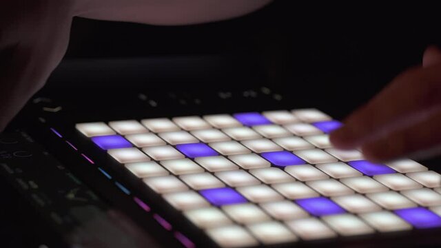 Close up of music producer using a sequencer in the studio to compose a song